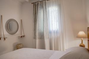 a bedroom with a bed and a window at Small Paradise in Andros