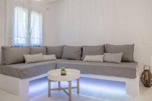 a living room with a gray couch and a table at Small Paradise in Andros