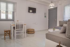 a living room with a couch and a table at Small Paradise in Andros