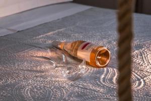 an empty bottle sitting on a table next to a rope at Small Paradise in Andros