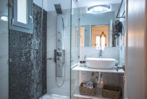 a bathroom with a sink and a glass shower at Small Paradise in Andros