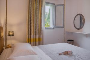 a bedroom with a bed and a window at Small Paradise in Andros