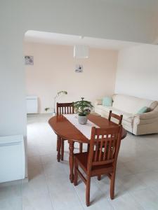 a living room with a table and chairs and a couch at LE CLOS VARNAY in Meusnes