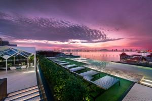 a row of benches on the roof of a building at The Prestige Hotel Penang, a Member of Design Hotels in George Town