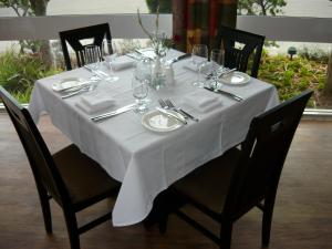 a dining room table with a white tablecloth at Hospitality Geraldton, SureStay by Best Western in Geraldton