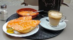 a breakfast of toast and a cup of coffee on a table at Malaga City Breaks in M&aacute;laga