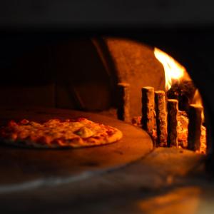 a pizza is coming out of an oven at Gran Hotel Guadalpín Banus in Marbella