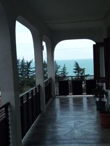 a balcony of a house with a view of the ocean at Guest House TeNi in Makhinjauri