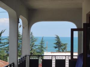 a view of the ocean from the balcony of a house at Guest House TeNi in Makhinjauri