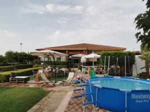 a pool in a yard with a house at Villa Rosa in Modica