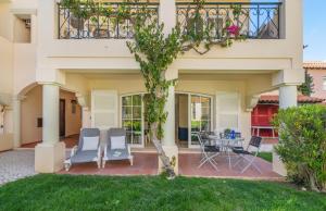 a house with a patio with chairs and a table at The Old Village, Prestige and Solar by Village 4U in Vilamoura