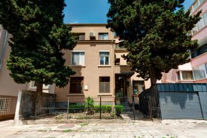 an apartment building with trees in front of it at Family Apartment - COMFORT IN THE CENTER in Burgas City