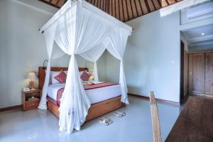 Postel nebo postele na pokoji v ubytování Nata Ubud