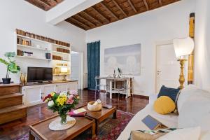 a living room with a couch and a table at Rome as you feel - Vetrina Terrace in Rome