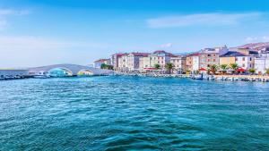 a view of a river with buildings and a bridge at Villa Antea - modern house with pool in Pag