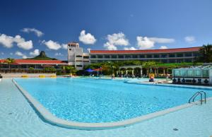 a large swimming pool in front of a building at Howard Beach Resort Kenting in Kenting