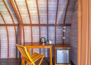 a room with a table and two chairs and a small table with a telephone at Megaland Bungalow in Nusa Penida