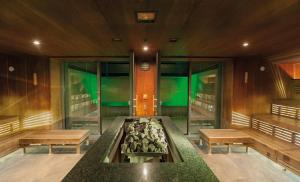 a room with benches and a fountain in the middle at Hotel Germania Gastein - ganzjährig inklusive Alpentherme Gastein in Bad Hofgastein