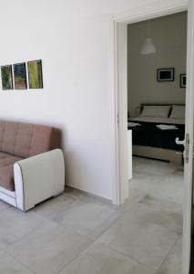 a living room with a couch and a bedroom at DoppioBi in Torre Lapillo