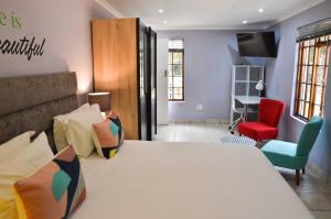 a room with a couch, chair, and a table at Kleinbosch Lodge in Stellenbosch