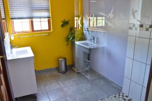 a bathroom with a sink, toilet and window at Kleinbosch Lodge in Stellenbosch