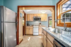 a kitchen with a stainless steel refrigerator and a sink at Good Harbor Haven in Gloucester