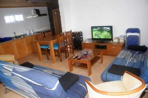 a living room with a couch and a tv at Retiro dos Cabritos in São Mateus