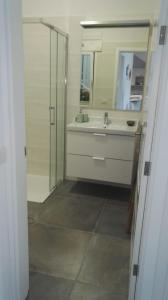 a bathroom with a sink and a mirror at Beautiful Apartament Arrieta in Haría +18 photos