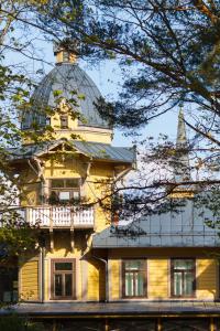 a building with a glass dome on top of it at Hotel Vila Diemedis in Palanga
