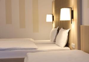 Postel nebo postele na pokoji v ubytování Hotel Brenner