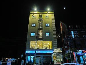 a tall building with a bird cage on top of it at Hotel Suraj Palace in Udaipur