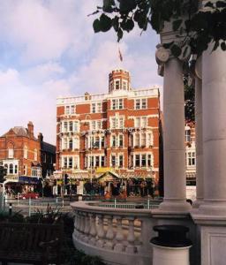 a large building in front of a building at Scarisbrick Hotel in Southport