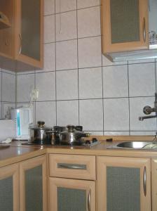 a kitchen with pots and pans on a stove at Apartament I in Rowy +2 photos