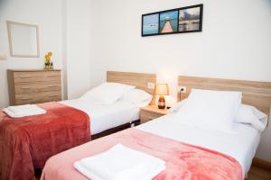 A bed or beds in a room at Casa Mamalola