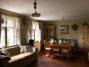 a living room with a couch and a table at Dom w Puszczy in Kwiejce Nowe
