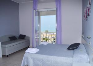 Posteľ alebo postele v izbe v ubytovaní Hotel Perla