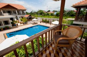 a view from the balcony of a villa with a swimming pool at Bambu Hotel in Battambang
