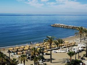 a view of a beach with umbrellas and the ocean at Gran Hotel Guadalpín Banus in Marbella