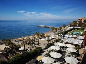 an aerial view of a beach with umbrellas and the ocean at Gran Hotel Guadalpín Banus in Marbella