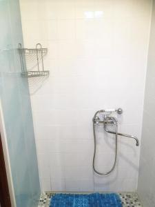 y baño con ducha y suelo de baldosa azul. en Ligatne's Village Studio Apartment, en Līgatne