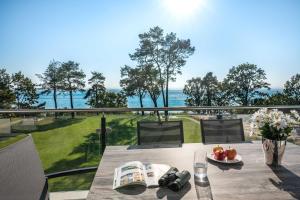 ein Tisch auf einem Balkon mit Blick auf das Meer in der Unterkunft Appartement "Karat" mit Penthouseflair - Oase am Haff in Garz