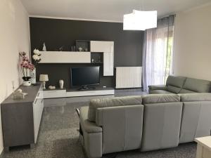 a living room with a couch and a television at CASA VACANZE LAPENTA in Montescaglioso