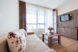 a living room with a couch and a table at Balchik Sea View Apartments in Princess Residence in Balchik