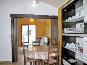 a dining room with a table and some chairs at Holiday Home Le Fournil by Interhome in Mimizan