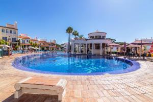 a large swimming pool in the middle of a resort at The Old Village, Prestige and Solar by Village 4U in Vilamoura