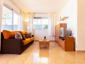 ein Wohnzimmer mit Sofa und Fernseher in der Unterkunft Holiday Home Flamenc 2 by Interhome in Riumar