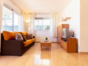 a living room with a couch and a tv at Holiday Home 2 Casas by Interhome in Riumar