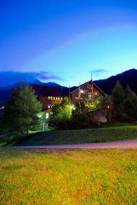 a house on a road in front of a yard at Hotel Garni Hainbacherhof in Sölden