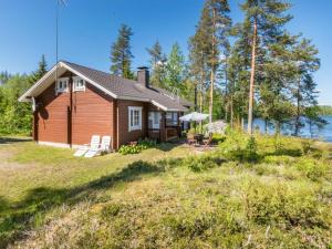 a cabin on a hill next to a body of water at Holiday Home Pajulintu by Interhome in Tiitanvaara