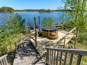 un muelle de madera con una parrilla junto a un lago en Holiday Home Villa pyöriäinen by Interhome, en Pihlajaniemi